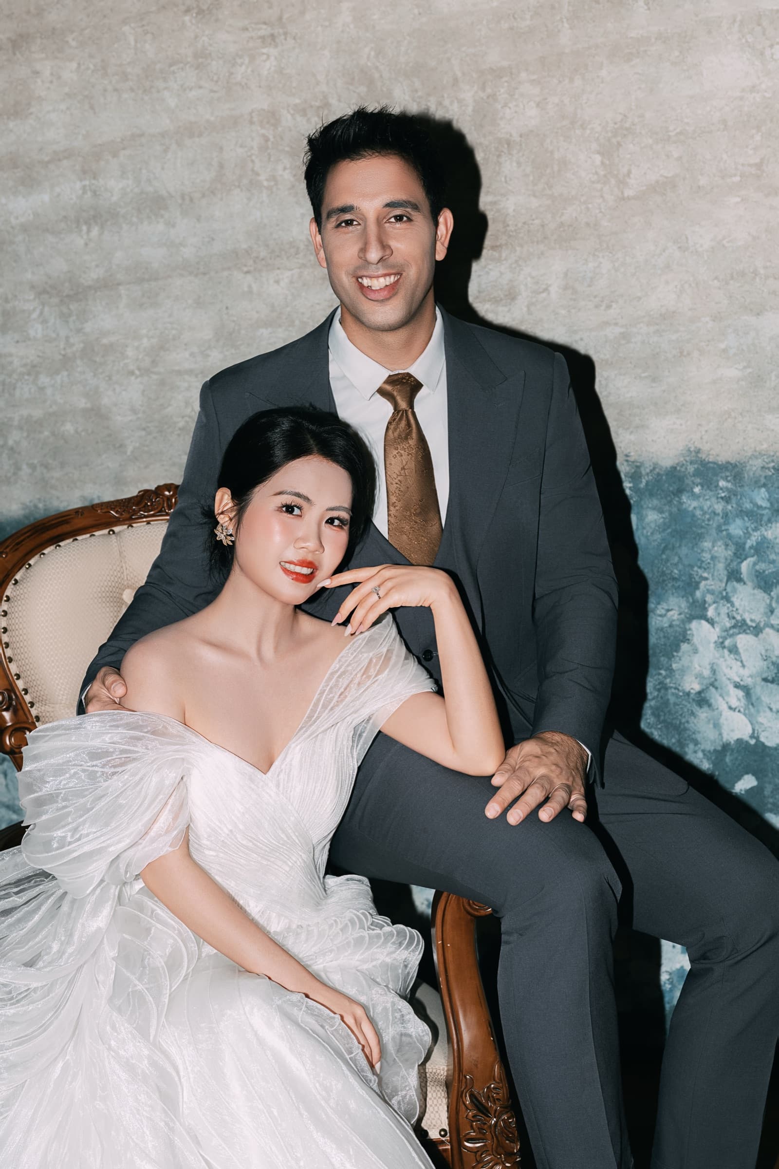 The couple seated together, smiling warmly